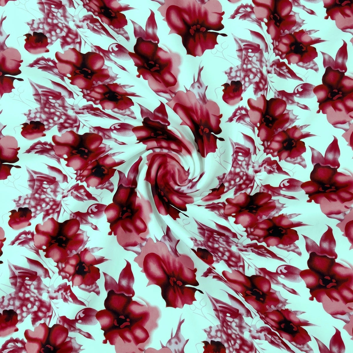 BLOMSTRET POLYESTERSTOF – RØD/ROSA – stoffet samlet i en blød swirl, med printet synligt (billede 1 af 3)