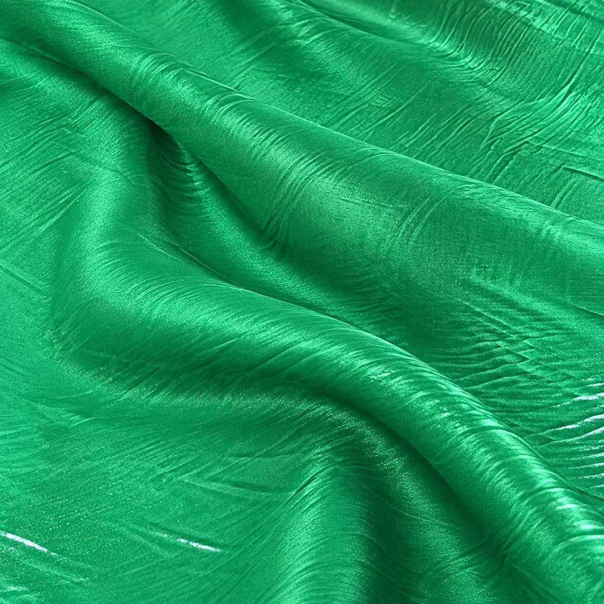 Metallic vintage grøn foil stof — nærbillede af foliens struktur og glans