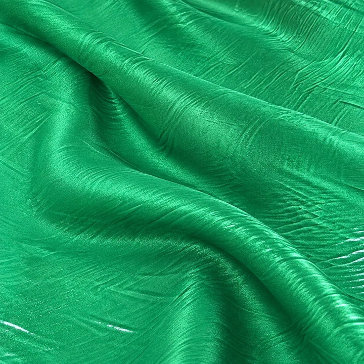 Metallic vintage grøn foil stof — nærbillede af foliens struktur og glans