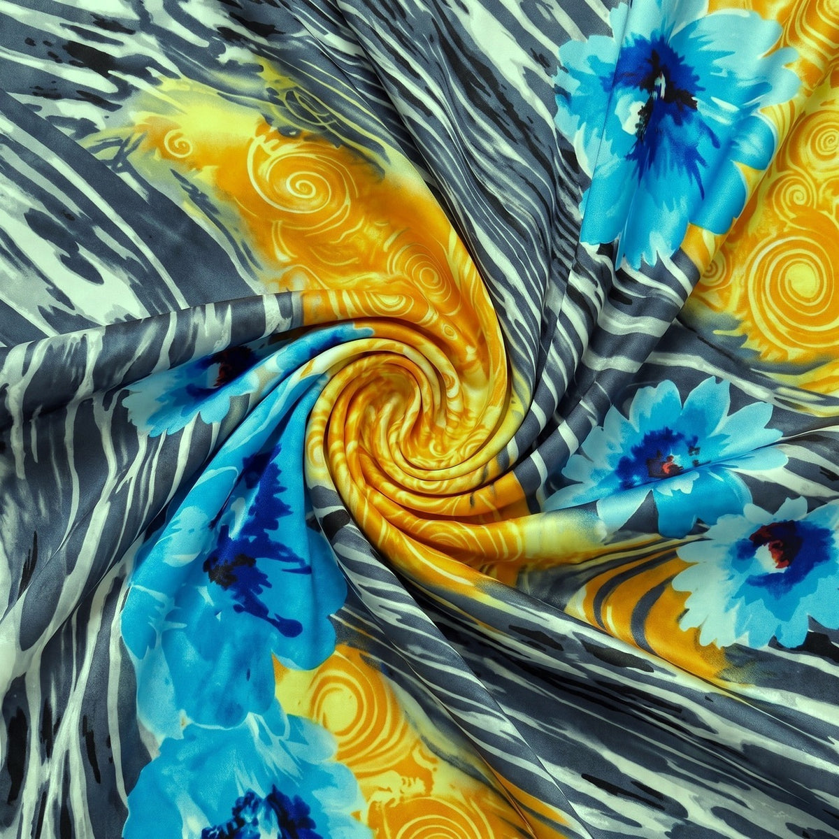 MØNSTRET POLYESTERSTOF – BLÅ/ORANGE/GRÅ – stoffet samlet i en blød swirl, med printet synligt (billede 1 af 3)