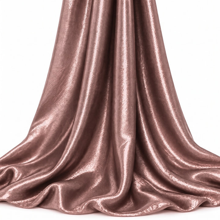 Støvet rosa foil stof — hængende og draperet, folien fanger lyset